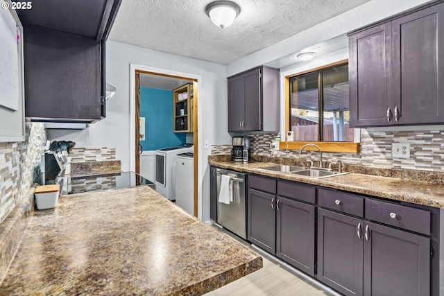 kitchen with washer and dryer, sink, backsplash, stainless steel dishwasher, and a textured ceiling