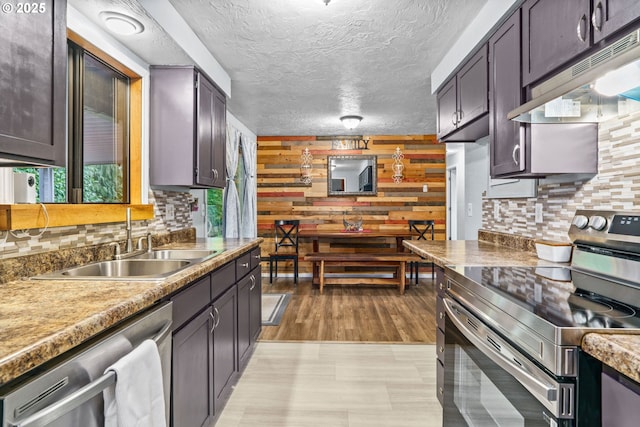 kitchen with tasteful backsplash, sink, dark brown cabinets, and appliances with stainless steel finishes