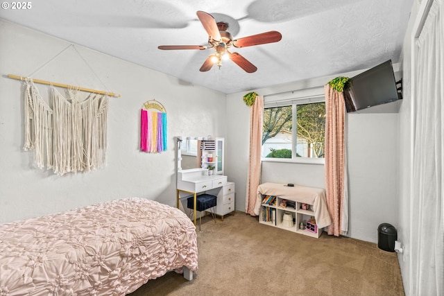 bedroom featuring ceiling fan, carpet flooring, and a textured ceiling