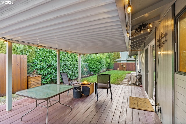 wooden deck featuring a lawn