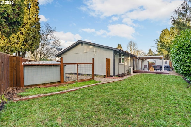 rear view of property featuring a yard and a deck