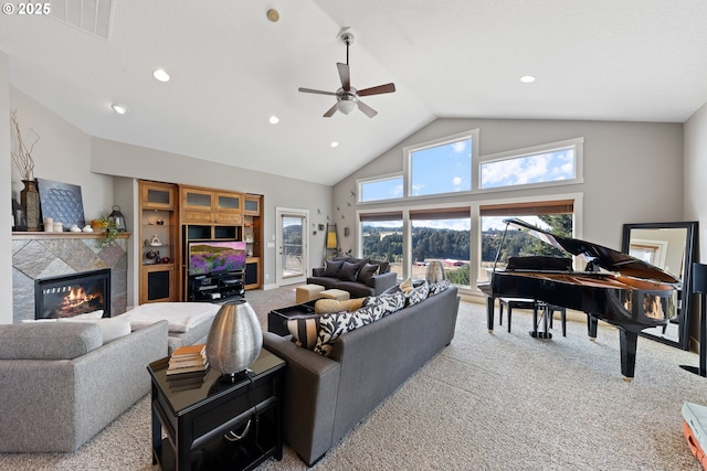 living room featuring a tiled fireplace, ceiling fan, carpet floors, and high vaulted ceiling