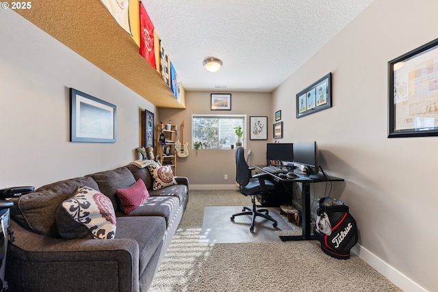 carpeted home office with a textured ceiling