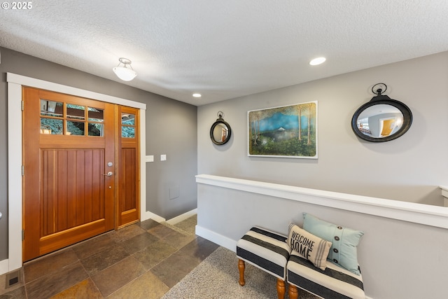 entryway featuring a textured ceiling