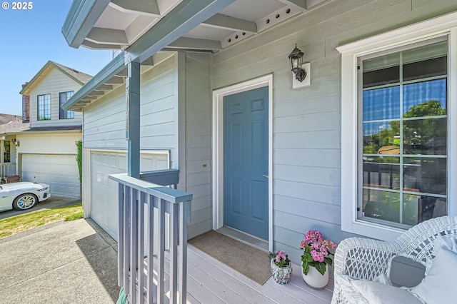 entrance to property featuring a garage and a porch