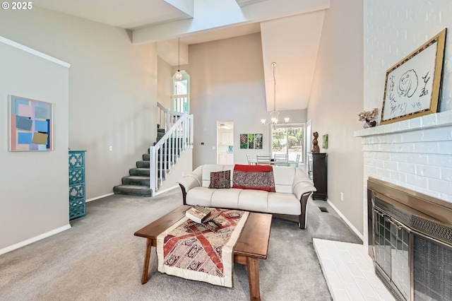 living area featuring stairs, a towering ceiling, carpet floors, baseboards, and a chandelier