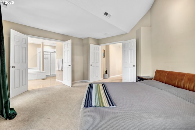 bedroom with light colored carpet, baseboards, connected bathroom, and lofted ceiling