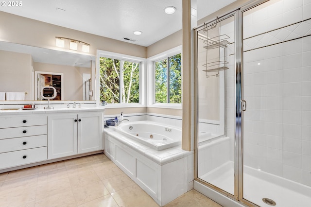 full bathroom with a stall shower, a tub with jets, vanity, and tile patterned floors