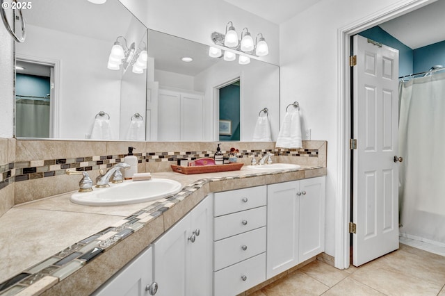 bathroom featuring backsplash, tile patterned floors, and double vanity