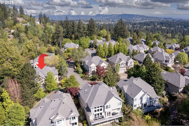 aerial perspective of suburban area featuring a heavily wooded area