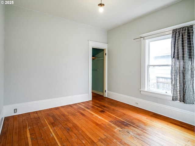 empty room with hardwood / wood-style flooring