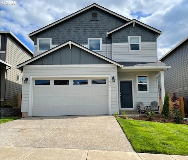 830 NE Buckthorn Dr, Estacada, OR 97023 - view of front facade featuring concrete driveway, a garage, a front lawn, and board and batten siding