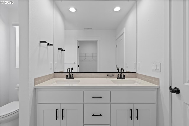 830 NE Buckthorn Dr, Estacada, OR 97023 - full bathroom featuring toilet, double vanity, recessed lighting, and a spacious closet