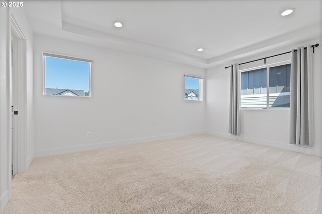 830 NE Buckthorn Dr, Estacada, OR 97023 - spare room featuring a raised ceiling, light colored carpet, recessed lighting, and baseboards