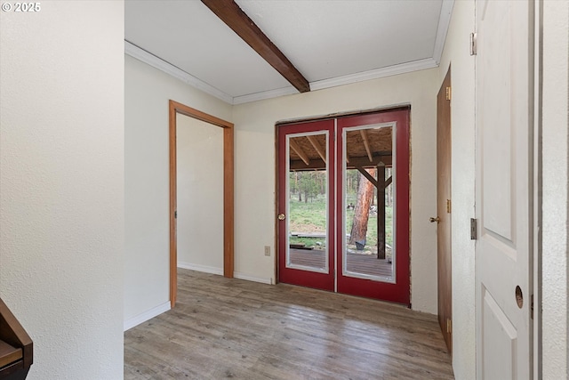 foyer with wood finished floors, beam ceiling, french doors, baseboards, and ornamental molding