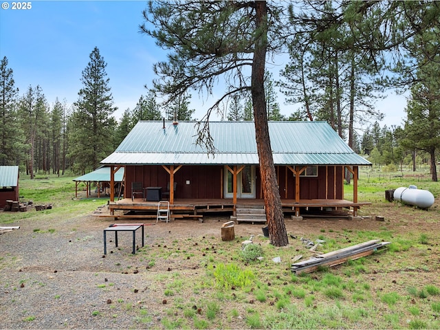 back of house featuring metal roof and board and batten siding