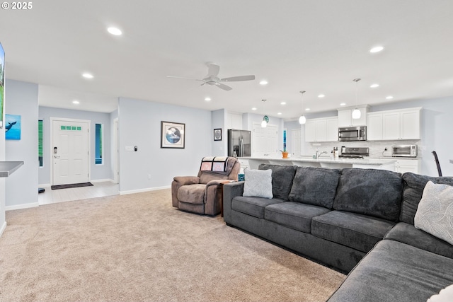 living room with a ceiling fan, baseboards, light colored carpet, recessed lighting, and a toaster