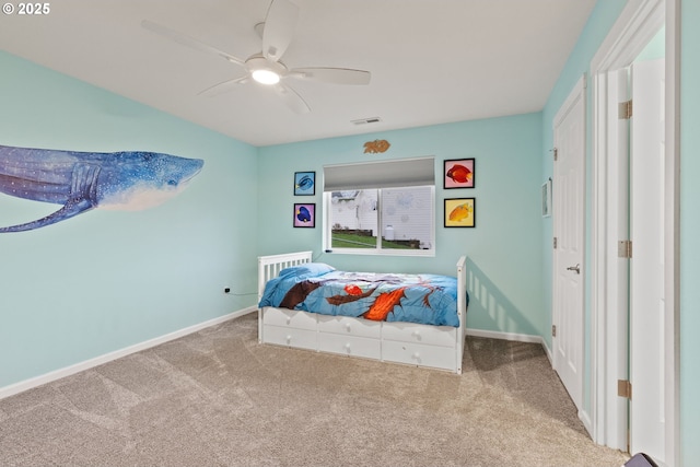 carpeted bedroom with a ceiling fan, baseboards, and visible vents