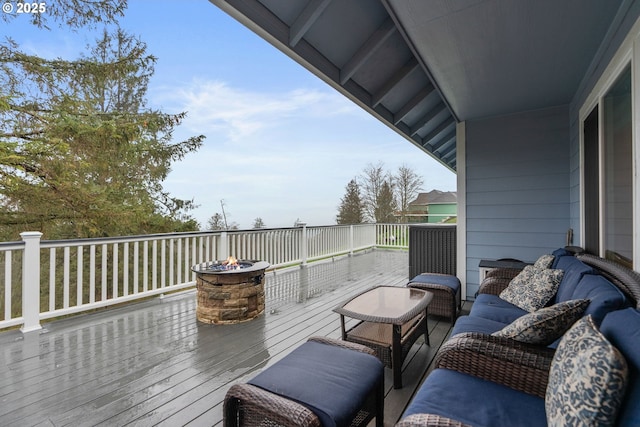 wooden terrace featuring a fire pit