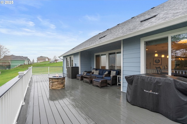 wooden deck with an outdoor living space with a fire pit