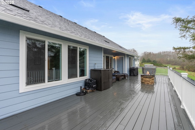 wooden deck featuring an outdoor fire pit