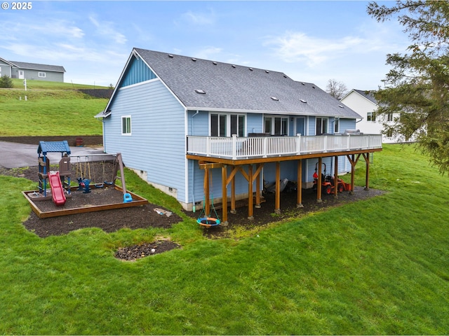 rear view of property featuring a lawn and a wooden deck