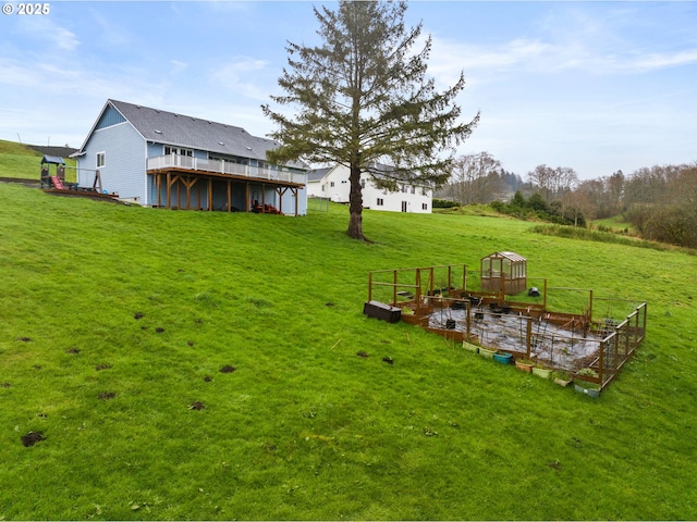 view of yard featuring a garden and a deck