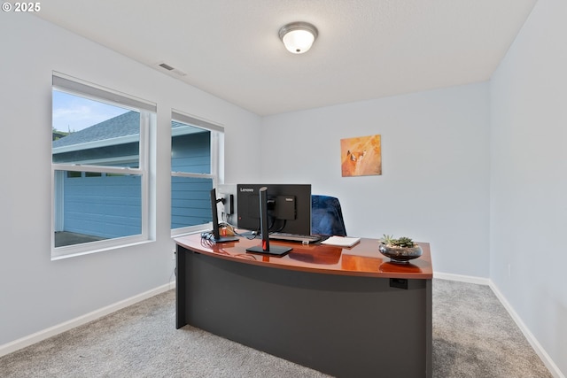 carpeted home office featuring baseboards and visible vents
