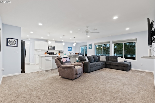 living room with baseboards, ceiling fan, recessed lighting, and light carpet
