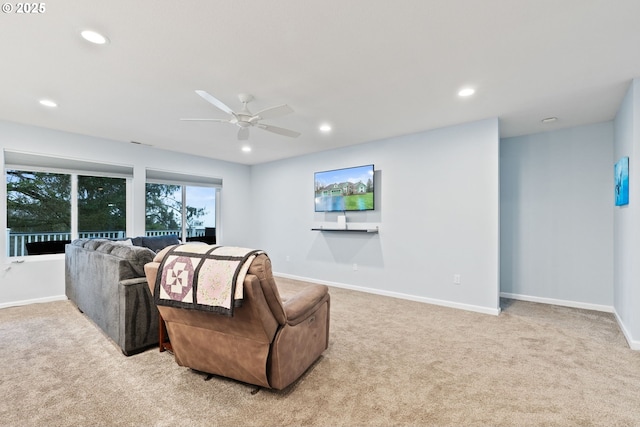 living room featuring recessed lighting, light carpet, baseboards, and ceiling fan