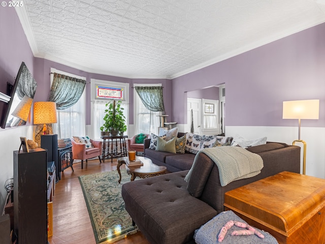 living room featuring hardwood / wood-style flooring and crown molding