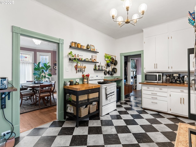 kitchen with butcher block counters, a chandelier, white cabinets, and white range with electric stovetop