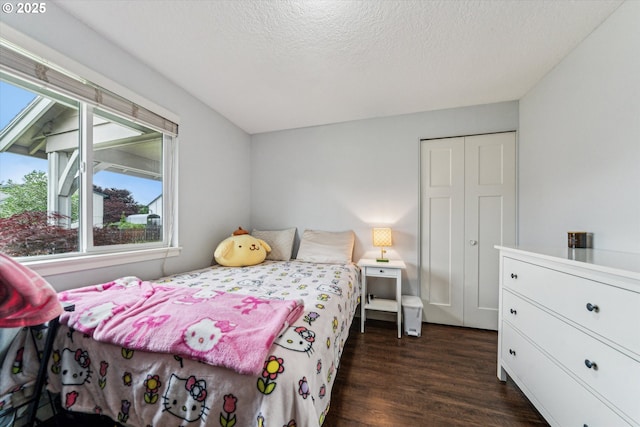 bedroom featuring a textured ceiling and dark wood-type flooring