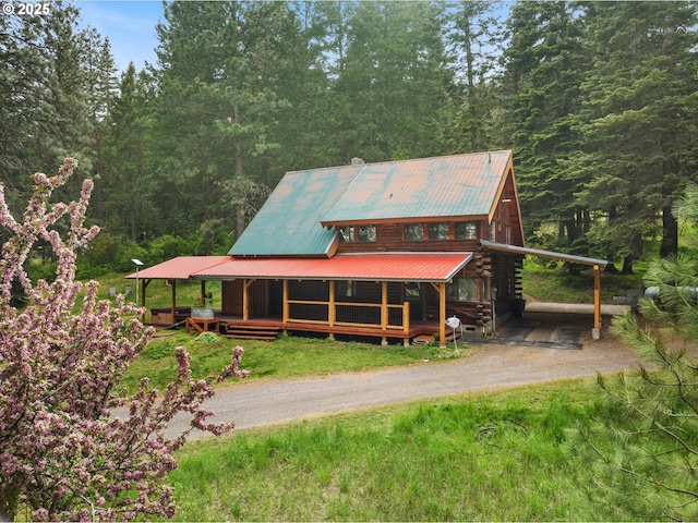 67388 Timberline Rd, Summerville, OR 97876 - view of front of home with driveway, metal roof, a forest view, and a porch