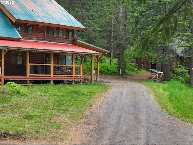 67388 Timberline Rd, Summerville, OR 97876 - view of front facade with metal roof, driveway, fence, and a view of trees