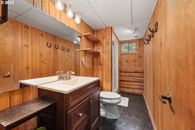 67388 Timberline Rd, Summerville, OR 97876 - bathroom featuring toilet, vanity, and wooden walls