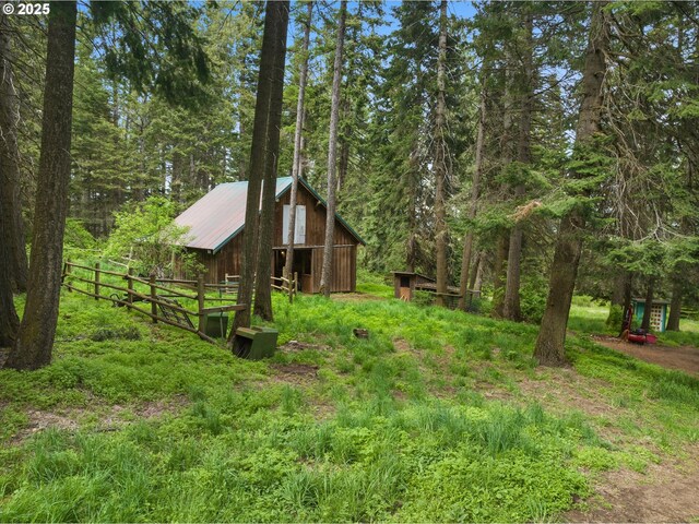 67388 Timberline Rd, Summerville, OR 97876 - view of yard with fence, an outdoor structure, and a view of trees
