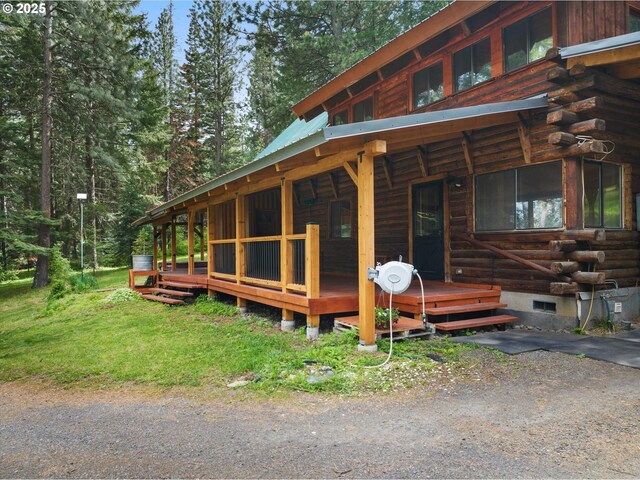 67388 Timberline Rd, Summerville, OR 97876 - view of front of house with log exterior, crawl space, and metal roof
