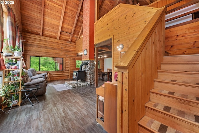 67388 Timberline Rd, Summerville, OR 97876 - living area featuring a wood stove, high vaulted ceiling, stairway, wooden ceiling, and wood finished floors