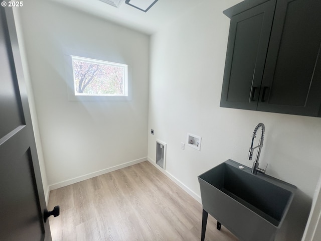 washroom with electric dryer hookup, light wood-type flooring, cabinet space, baseboards, and hookup for a washing machine
