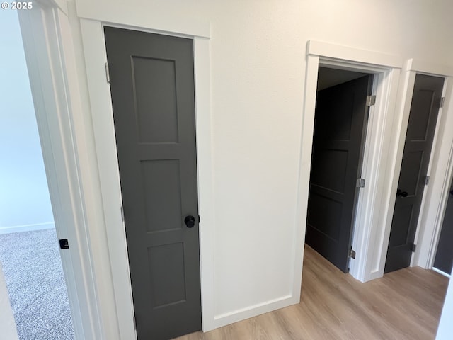 interior space with baseboards and light wood-style floors