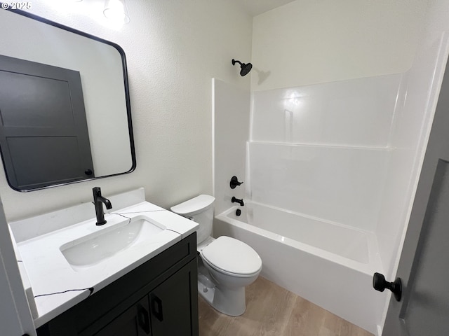bathroom featuring vanity, shower / bathtub combination, wood finished floors, and toilet