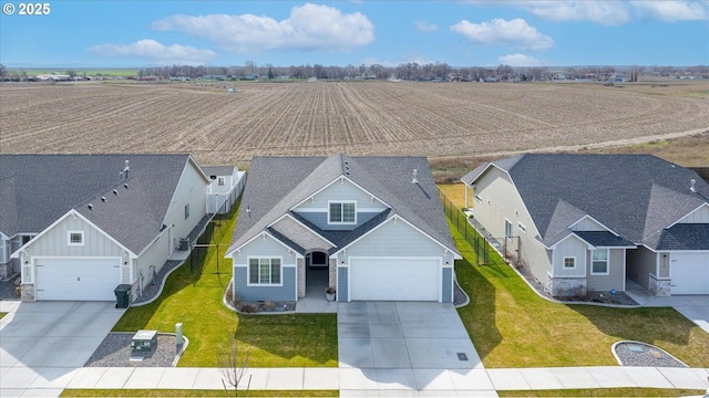 birds eye view of property with a rural view