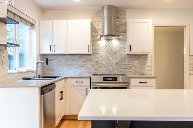 3166 NE Glencoe Oaks Pl, Hillsboro, OR 97124 - kitchen with wall chimney exhaust hood, stainless steel dishwasher, stove, and plenty of natural light