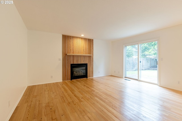 3166 NE Glencoe Oaks Pl, Hillsboro, OR 97124 - unfurnished living room with a fireplace, light wood finished floors, and recessed lighting