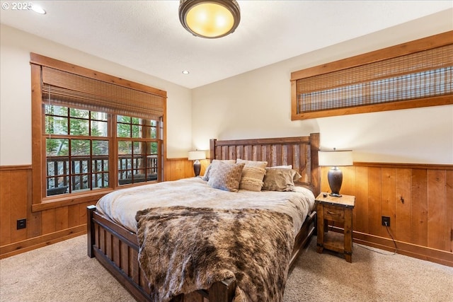 carpeted bedroom with wainscoting, wooden walls, and recessed lighting