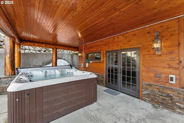 view of patio with a hot tub and french doors