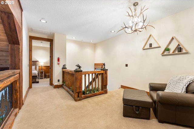 sitting room with light colored carpet, recessed lighting, a chandelier, and baseboards