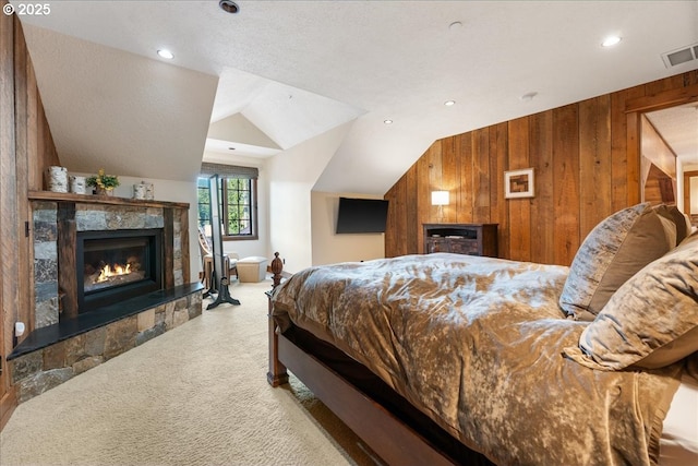 bedroom featuring a fireplace, carpet, wooden walls, vaulted ceiling, and recessed lighting