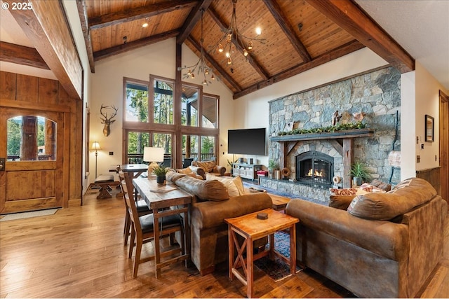 living room with wooden ceiling, beam ceiling, hardwood / wood-style floors, high vaulted ceiling, and plenty of natural light
